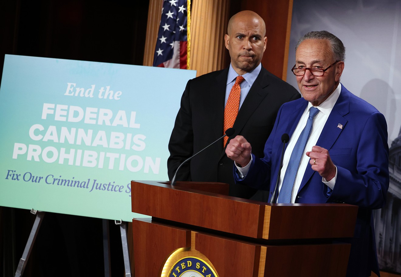 U.S. Senators Corey Booker (D-NJ) and Chuck Schumer (D-NY)  at a July 2021 press conference on introducing legislation to end federal cannabis prohibition.
