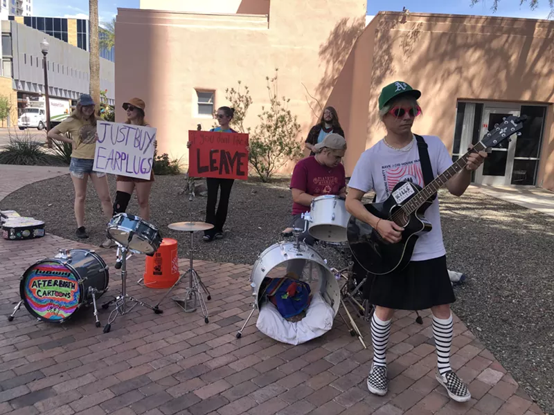 Image: Protesters drum and hold signs outside Mirabella at ASU on April 15, 2022.