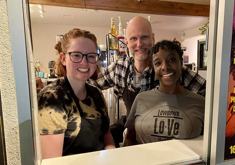Image: (Left to right) Lowdown Vegan manager Frankie O’Neill and owners Theron Evans and Jai Jones pose in the window of Arizona's first vegan fast food drive-thru.