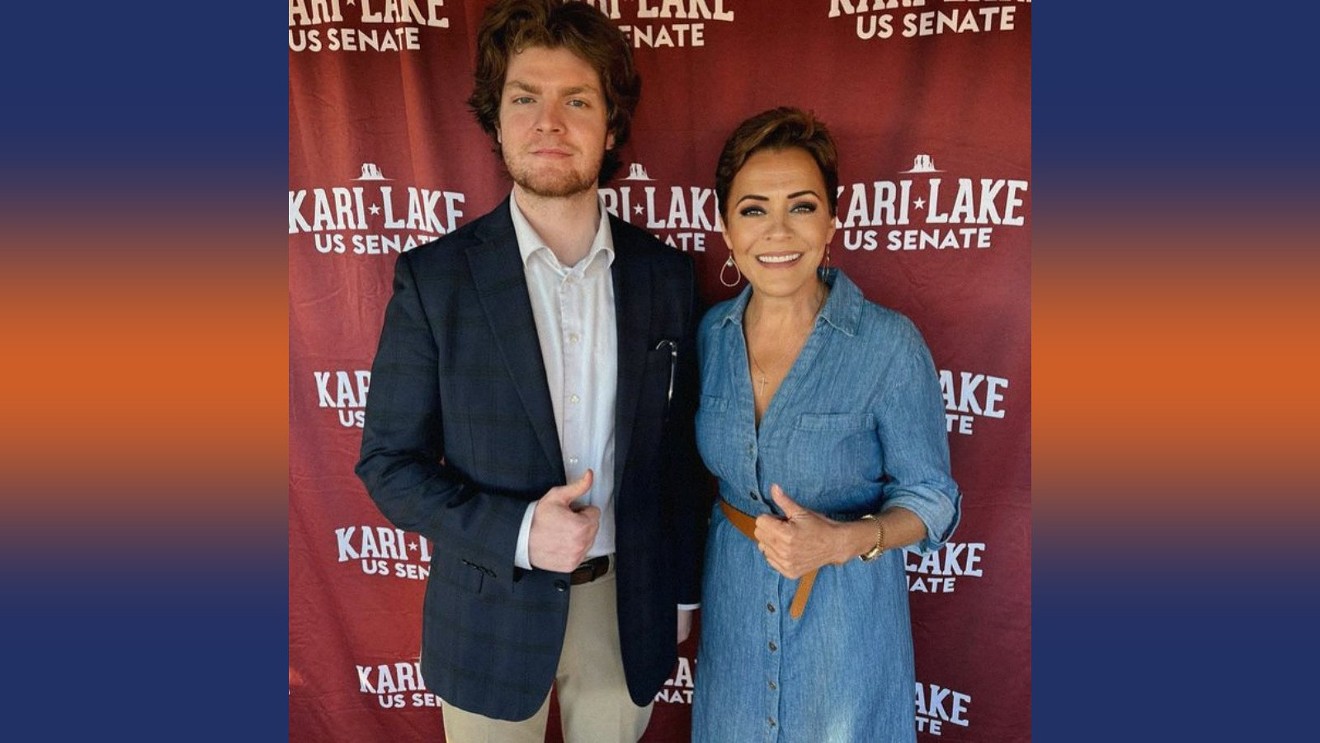 Wade Searle poses with Kari Lake at a March 3 event that Lake, a GOP candidate for Senate, held for campaign volunteers.