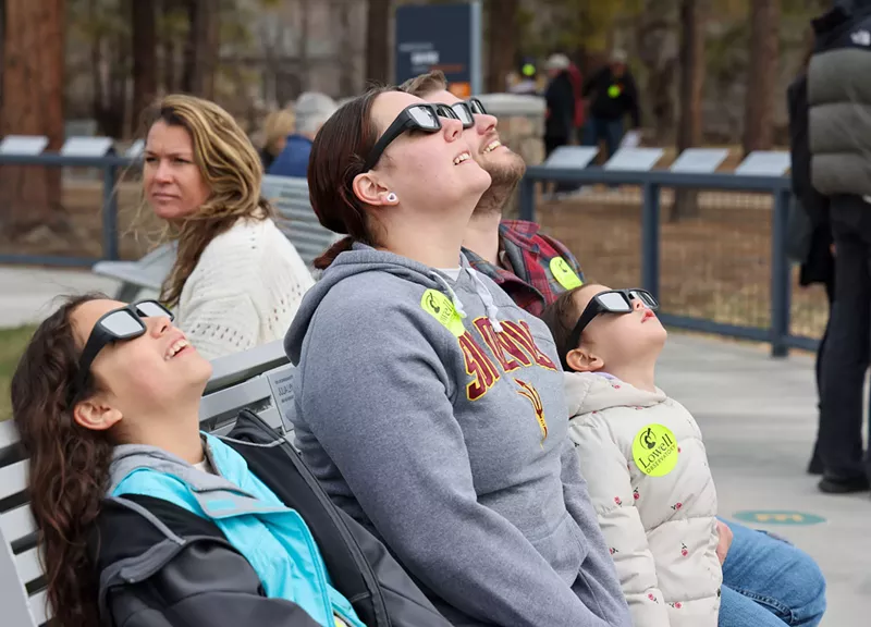 Image: From left, Amelia, Megan, Ariel and Jarrot Kronenwetter wear protective glasses as they look at the eclipse Monday outside the Lowell Observatory in Flagstaff.