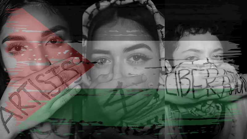 Image: Bianey Luna, Christina Valles and E Rizo, members of Artists 4 Liberation pose for the camera with the name of the human-rights advocacy organization written on their hands