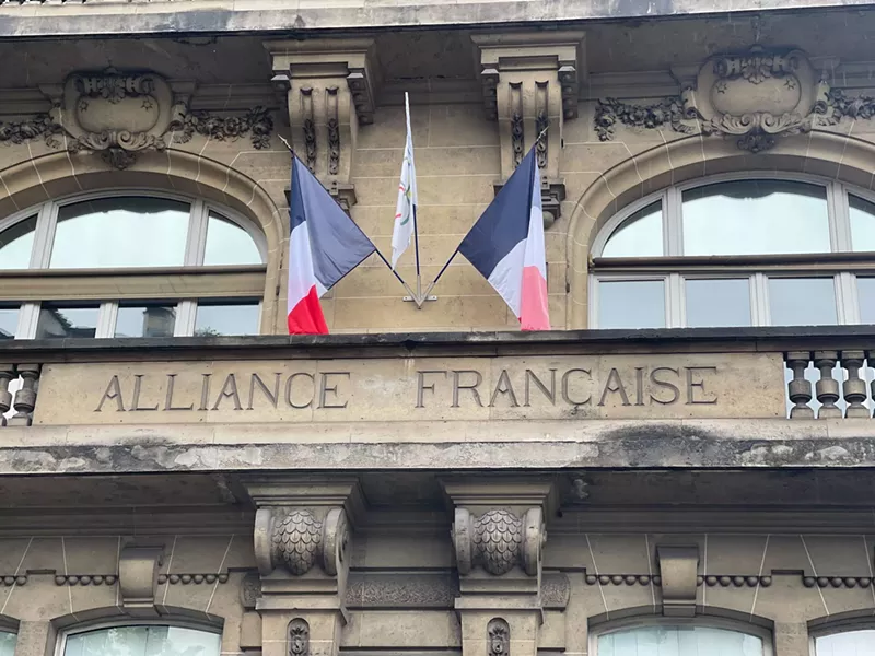 Image: A building in France with a French flag flying on it.