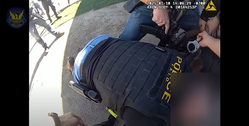 Image: body-cam footage of a man being arrested by a host of officers
