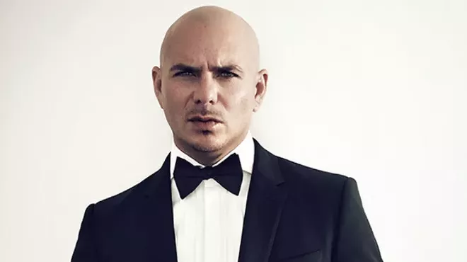 A man in a tuxedo against a white background.