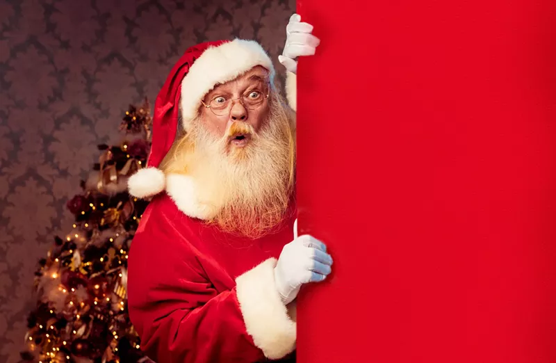Image: a shocked santa peeks around a corner