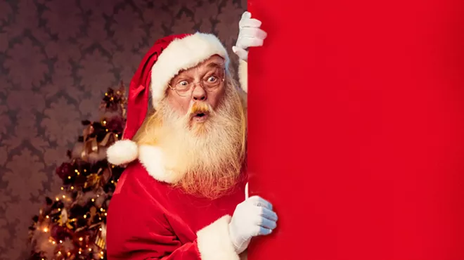a shocked santa peeks around a corner
