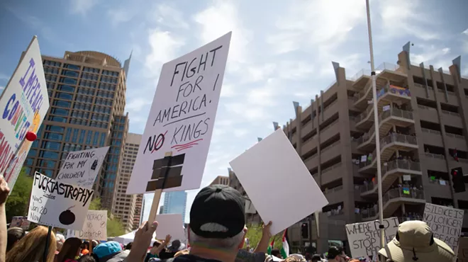 protesters hold signs in the air
