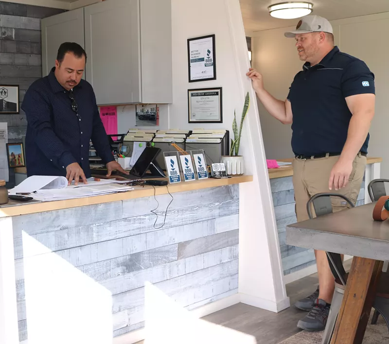 Image: Luke Crosthwaite (left) and Josh Bleak (right), discuss plans for Crosthwaite Custom Construction shipping container apartments in Apache Junction.