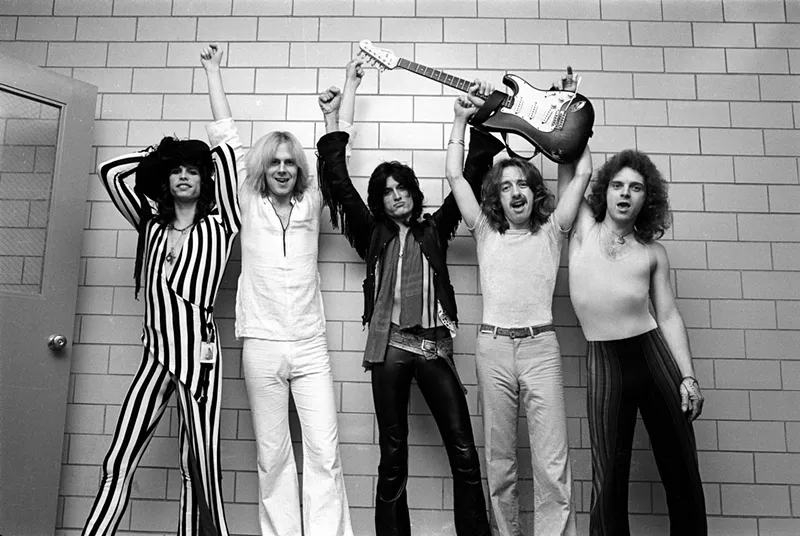Image: A black and white photo of the rock band Aerosmith.
