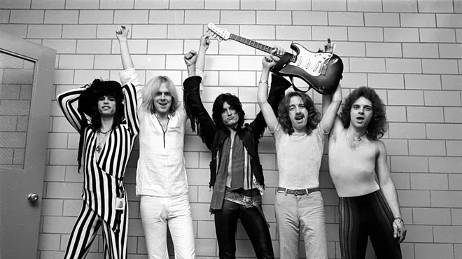 A black and white photo of the rock band Aerosmith.