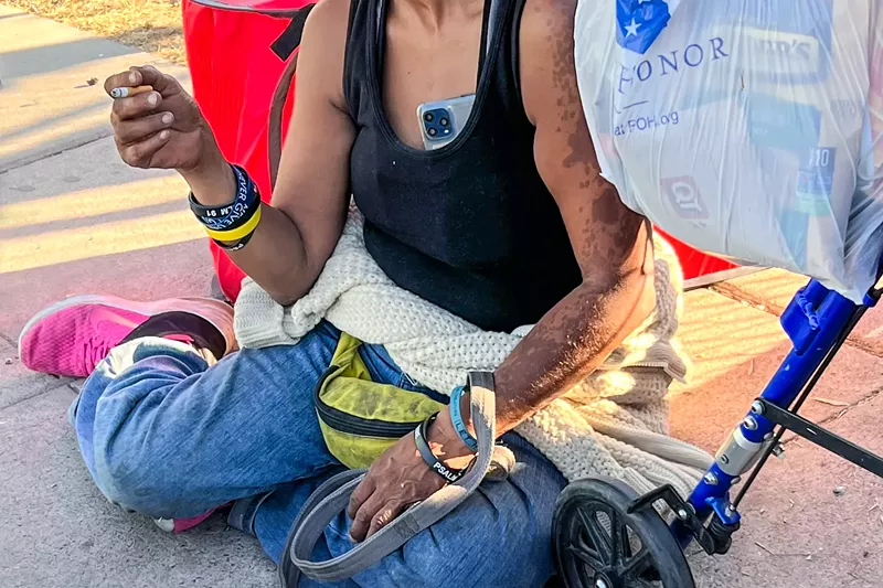 Image: Some residents in the Zone wear bright rubber bracelets with motivational phrases and psalms printed in white, providing a stark contrast to the environment around them on Oct. 11.