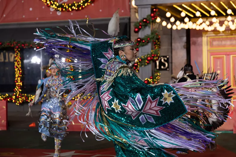 Image: A Native American woman performs a dance.