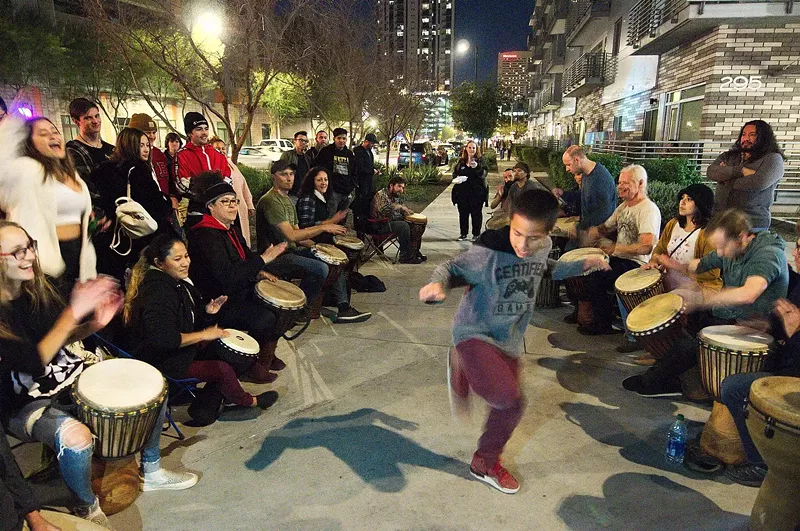 Image: A young attendee of First Friday dances during a drum circle along Roosevelt Row in February 2020.