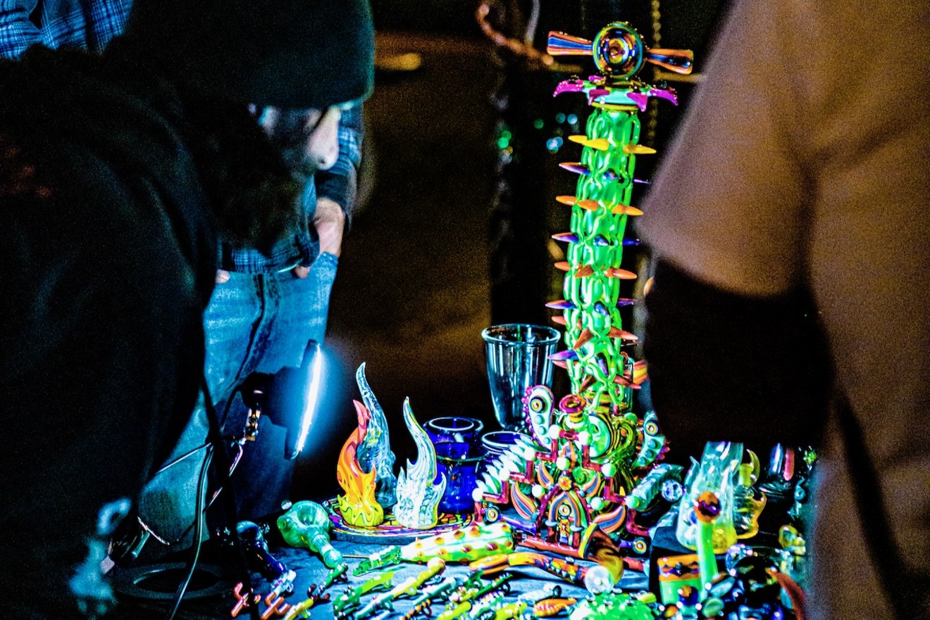 A patron examines the Tryptamine Tower, a piece of glasswork by Brian Jacobson, during the annual Hendy’s Heady Holiday showcase at Bud's Glass Joint on Dec. 16.