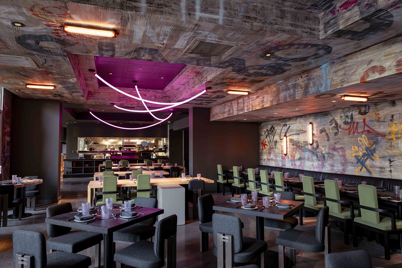 Kembara's dining room features Japanese-style furniture and graffiti walls inspired by chef Angelo Sosa's travels through the Malaysian state of Penang.