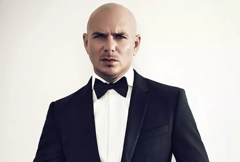 Image: A man in a tuxedo against a white background.
