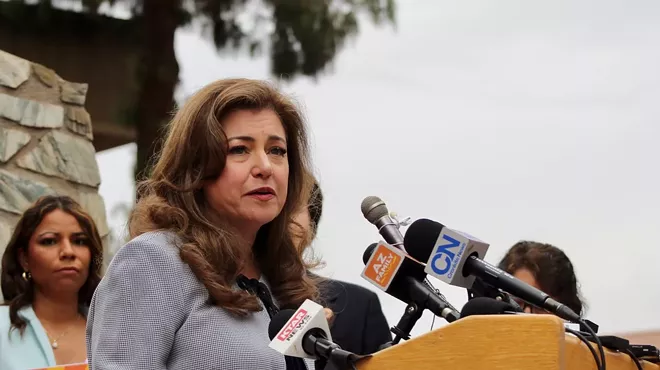Mónica Villalobos speaks at podium