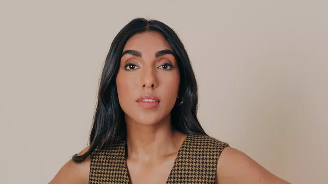 A portrait of a young woman of color.