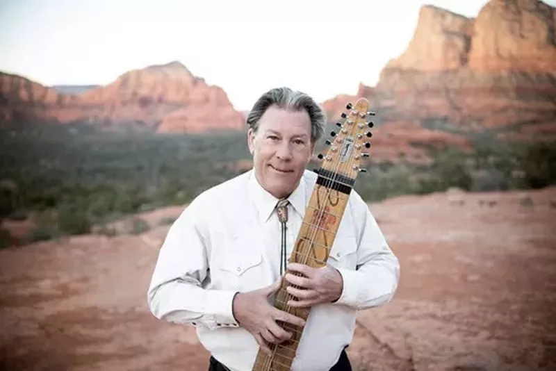 Image: Chapman Stick expert Michael Kollwitz holds his instrument near his home in Sedona.