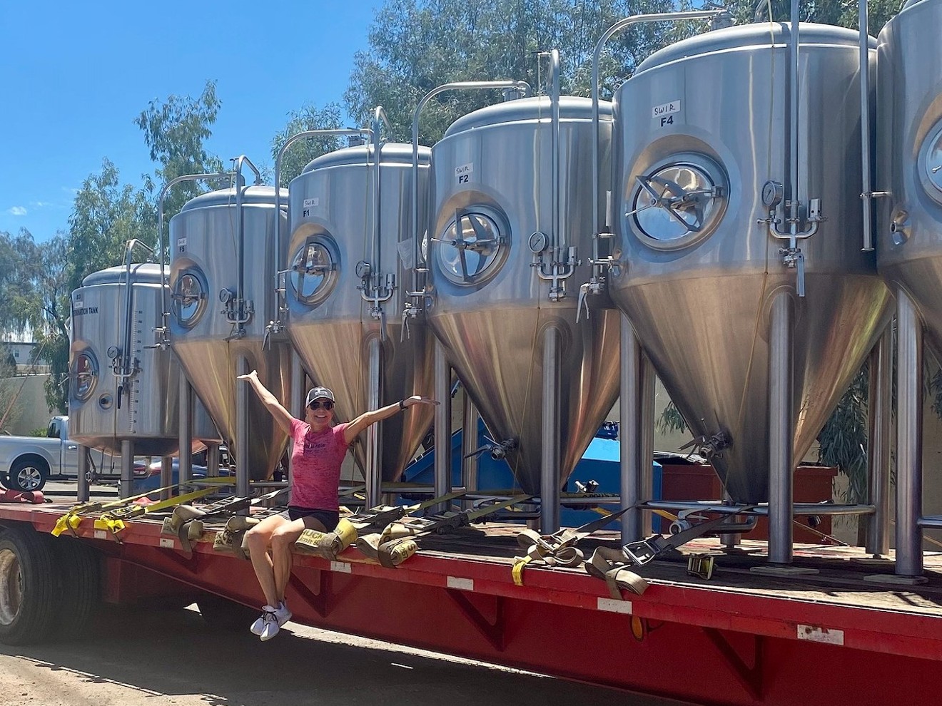 Hundred Mile Brewing Company owner Sue Rigler rejoices over the arrival of the tanks for her 10-barrel brewhouse.
