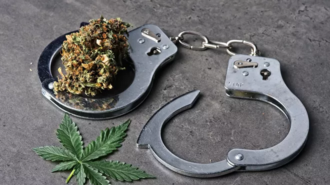 handcuffs around a weed flower