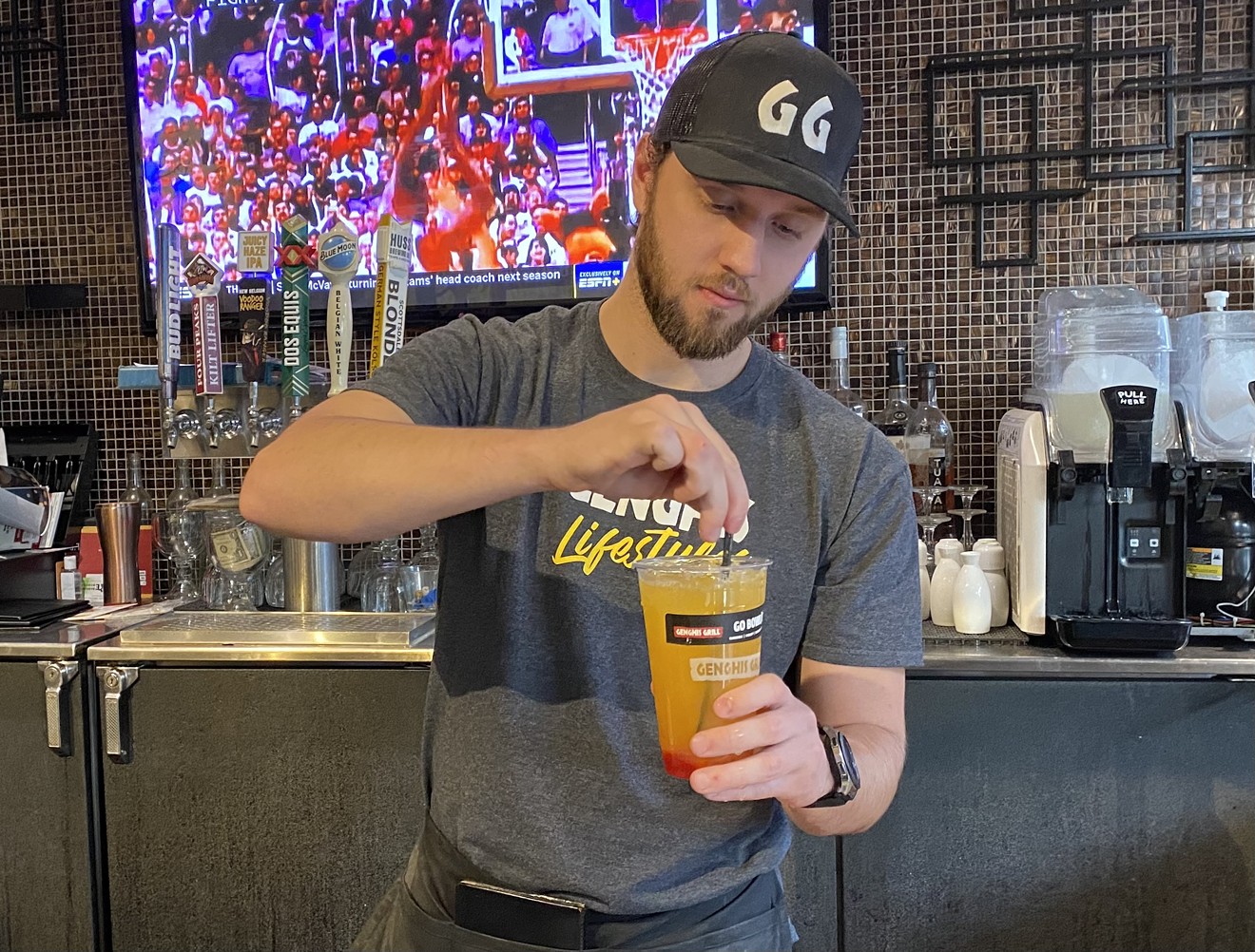 Cade Cummings mixes a drink to go at Genghis Grill at Tempe Marketplace on January 13.
