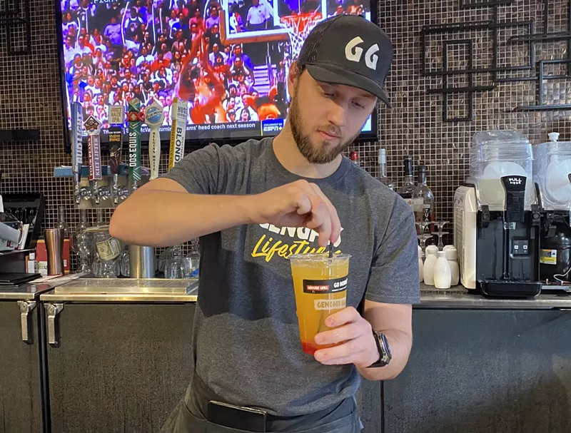 Image: Cade Cummings mixes a drink to go at Genghis Grill at Tempe Marketplace on January 13.