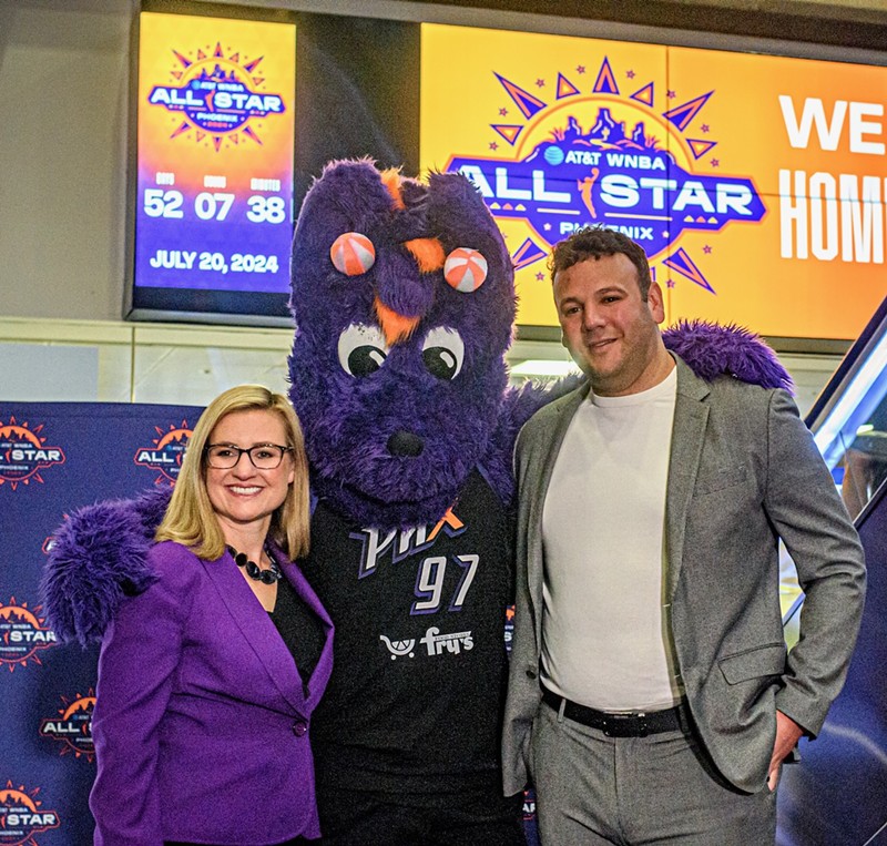 Phoenix Mayor Kate Gallego and Phoenix Suns and Phoenix Mercury CEO Josh Bartelstein pose for a photo with Mercury mascot Scorch after the unveiling of the WNBA All-Star Game Countdown Clock at Phoenix Sky Harbor International Airport.