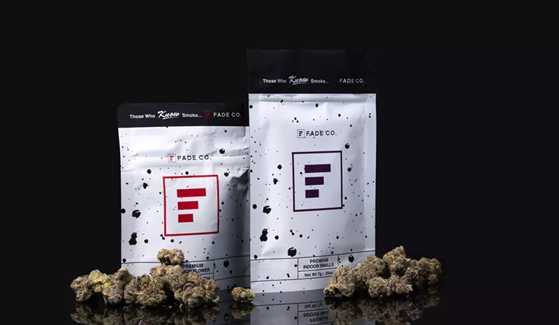 Image: Bags of Fade Co. cannabis surrounded by buds of marijuana.