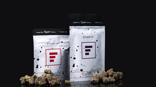 Bags of Fade Co. cannabis surrounded by buds of marijuana.
