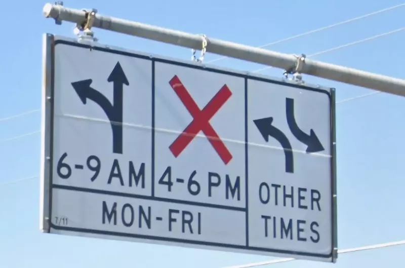 Image: a sign that shows left turns ok during some hours, prohibited during others