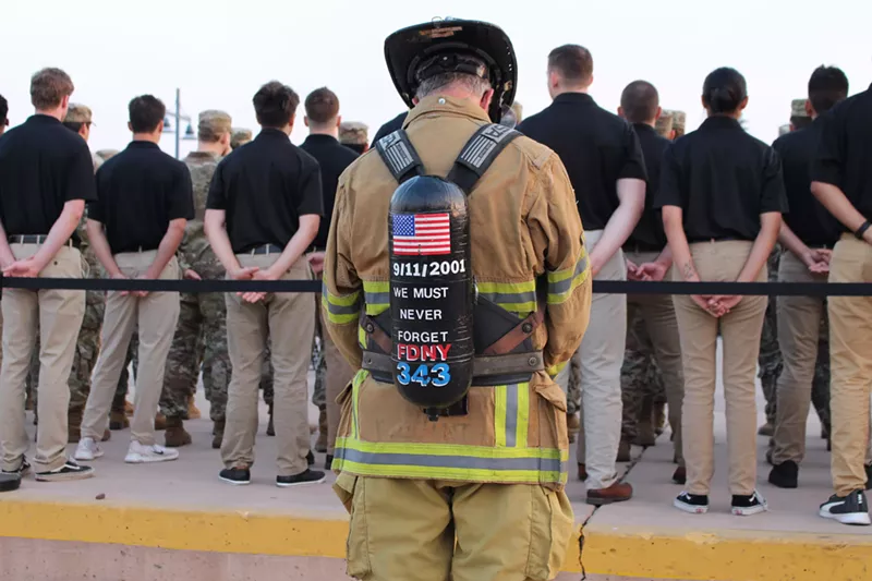 Image: A firefighter bows his head during a 9/11 memorial at the Tempe Healing Field on Sept. 11, 2024.