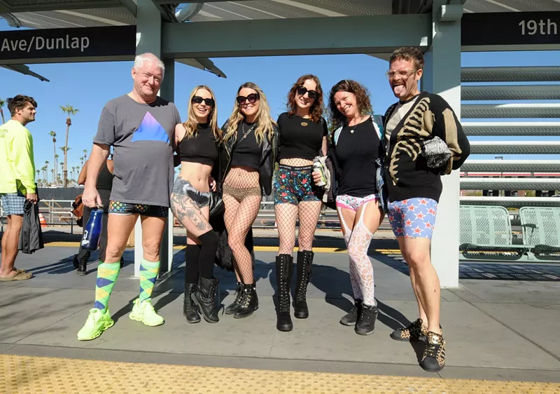 Image: Participants of the No Pants Light Rail Ride 2024 in Phoenix at the Valley Metro Rail station at Dunlap and 19th avenues.