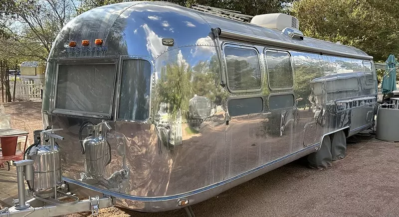 Image: A 1950 Spartan Mansion is one of the trailers you can stay in at The Cozy Peach at Schnepf Farms.