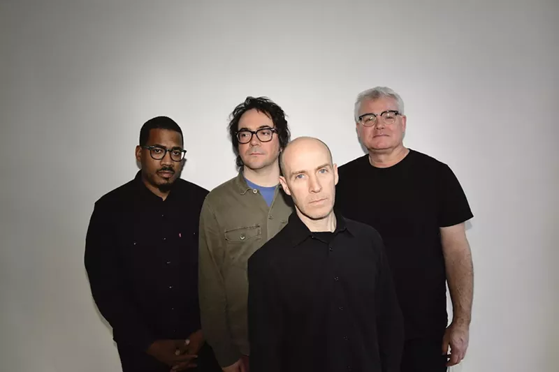 Image: A rock band posing for the camera.