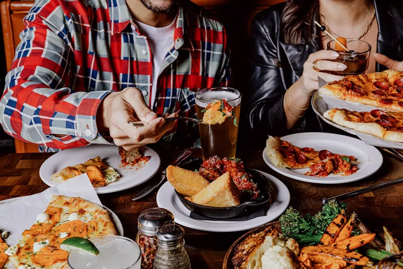 Image: Digging in at a table full of food.