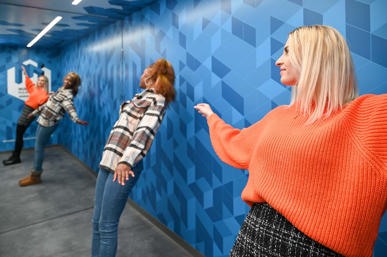 In the Ames Room at the Museum of Illusions, people appear to grow and shrink as they walk from one side to the other.