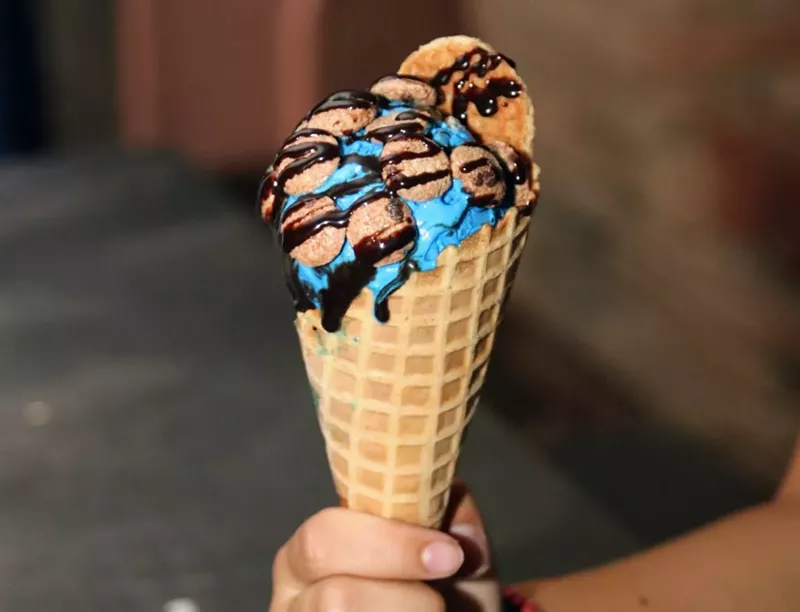 Image: Cookie Monster, a staple flavor, is electric blue-colored vanilla ice cream often requested topped with Cookie Crisp pieces and chocolate drizzle.