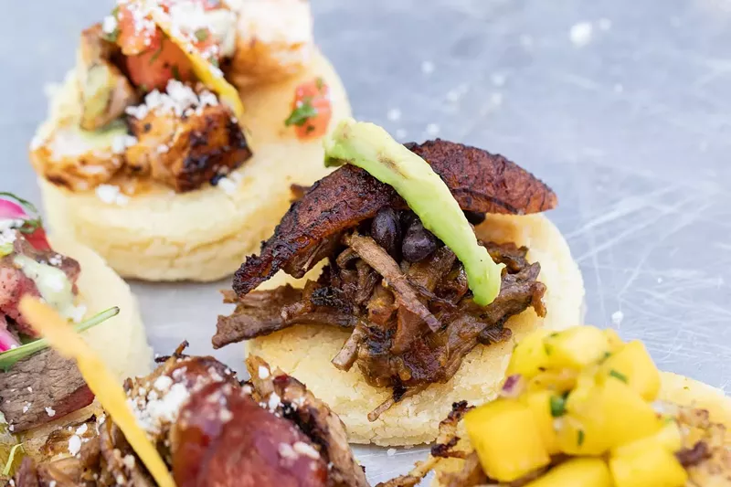 Image: At the new Que Sazon, look for dishes like mini arepas with pork and chorizo or pollo and mango.