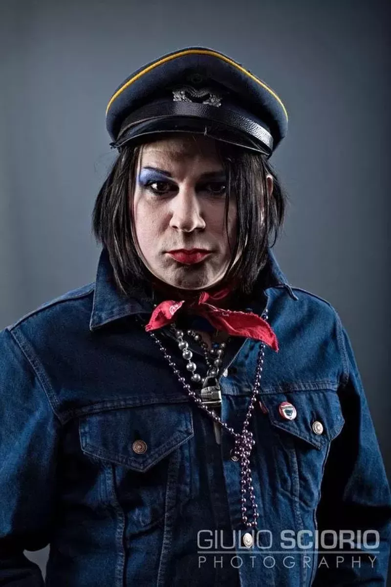 Image: A man dressed up in punk rock clothing and makeup.