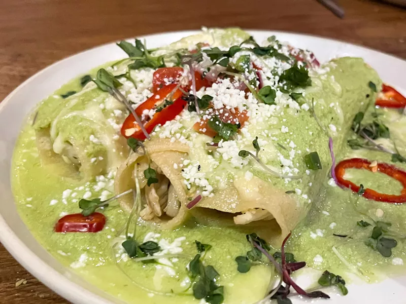 Image: Enchiladas, filled with chicken, a drenched with a fresh and bright salsa verde.