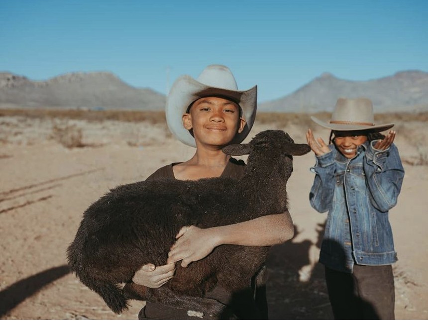 James, 12, and Zinaye, 11, help with livestock around the ranch. - IVAN MCCLELLAN