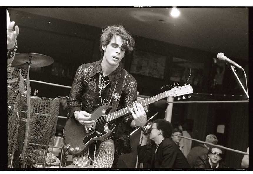 Doug Clark of Mighty Sphincter plays guitar at Mad Gardens in Phoenix in the early 1980s. A young Michael Cornelius is taking pictures in the background. - JOSEPH CULTICE
