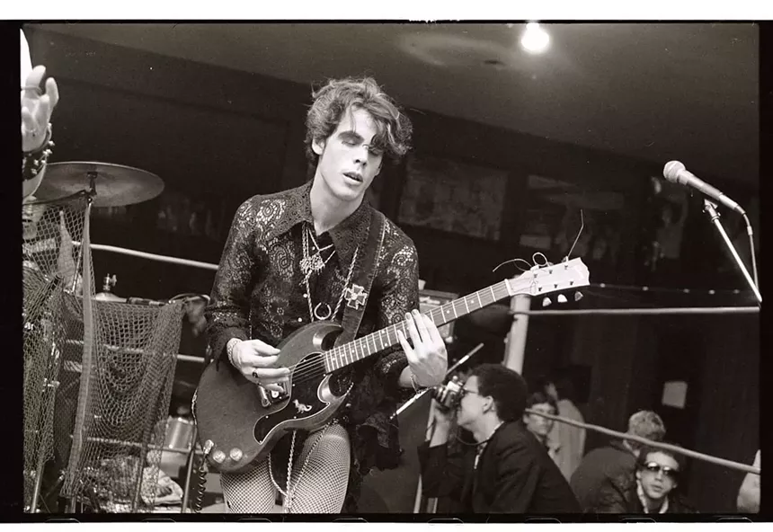 Doug Clark of Mighty Sphincter plays guitar at Mad Gardens in Phoenix in the early 1980s. A young Michael Cornelius is taking pictures in the background. - JOSEPH CULTICE