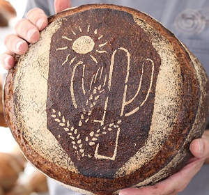 Barrio's lovely Locavore loaf showcases three organic local flours and a desert scene.  - NEIGHBORHOOD BREAD