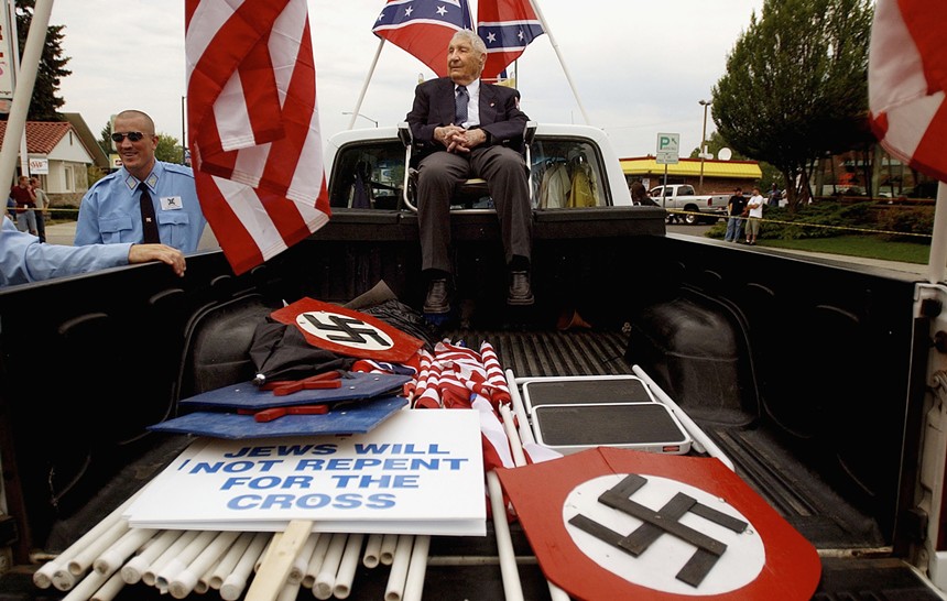 Rev. Richard Butler, one-time leader of the Aryan Nations, in the back of a truck at the beginning of the World Congress Parade in Coeur d’Alene, Idaho, in 2004. - JEROME POLLOS / STRINGER / GETTY IMAGES