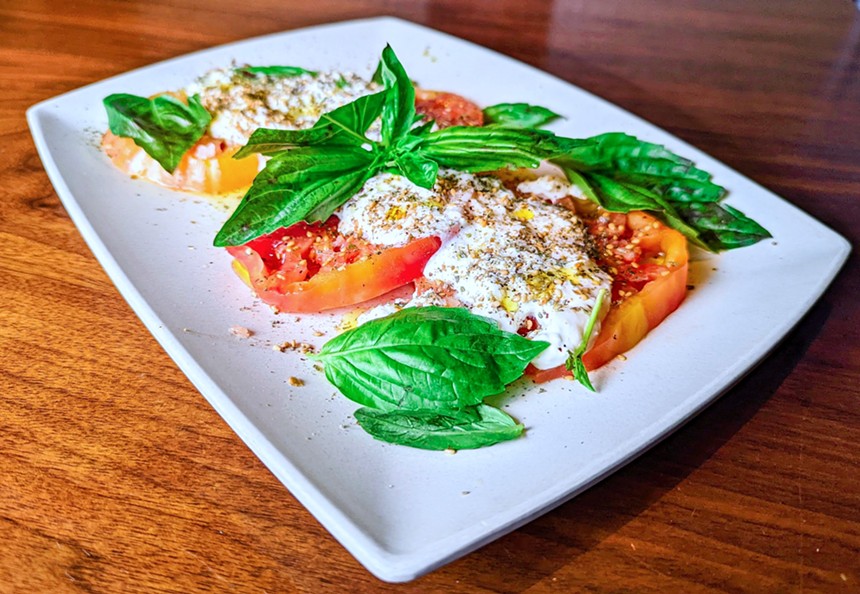 The Caprese tops heirloom tomatoes, stracciatella cheese and basil with a savory hit of za'atar spice. - BITTER & TWISTED