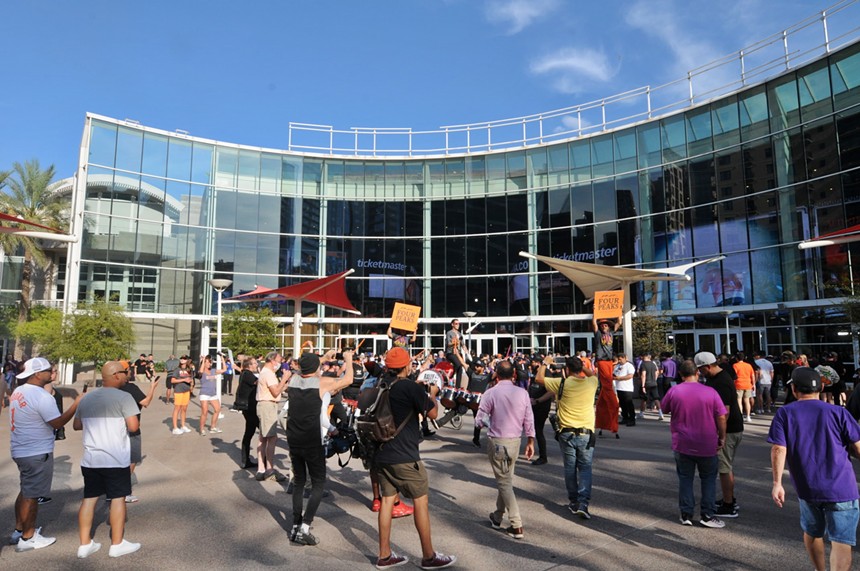 Suns fans wait outside of Footprint Center in downtown Phoenix. - BENJAMIN LEATHERMAN