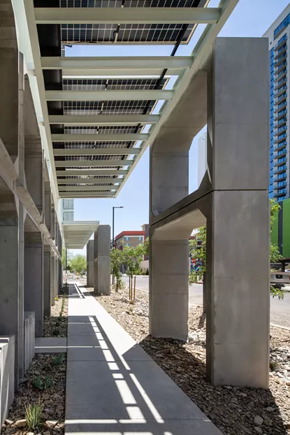 A unique solar overhang spans the length of the six-story building, obscuring the sidewalk below in shade. - WILLIAM LEGOULLON
